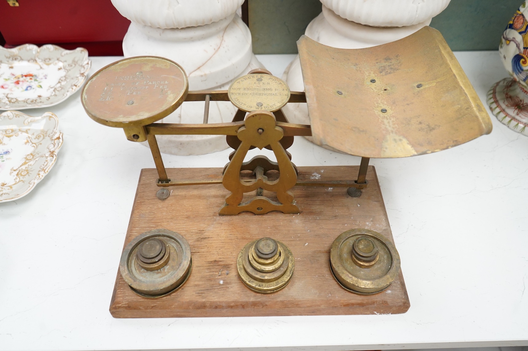 A set of brass and mahogany Avery postal scales and weights, 37cm wide